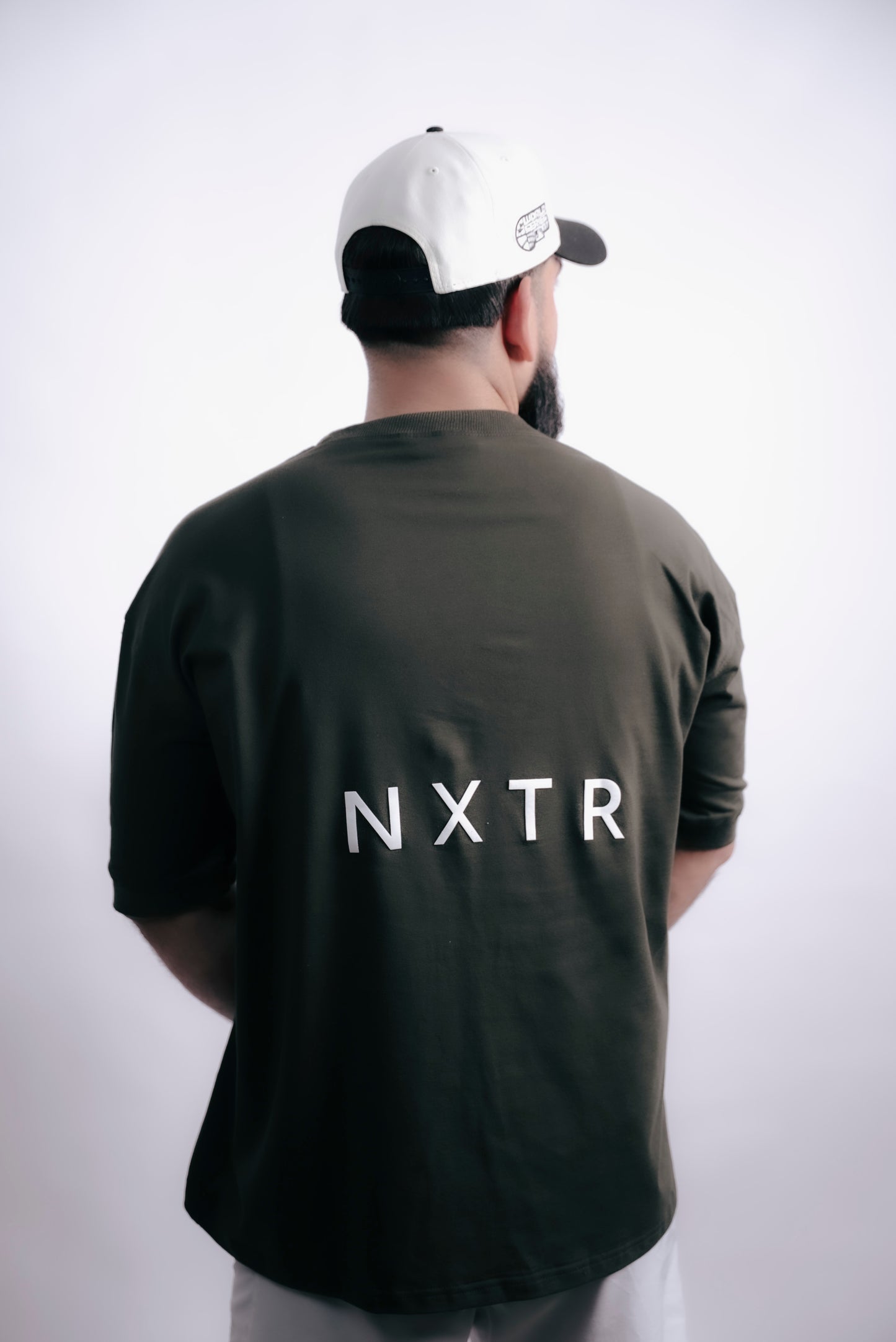 Military green oversized — subtle flex, strong presence.