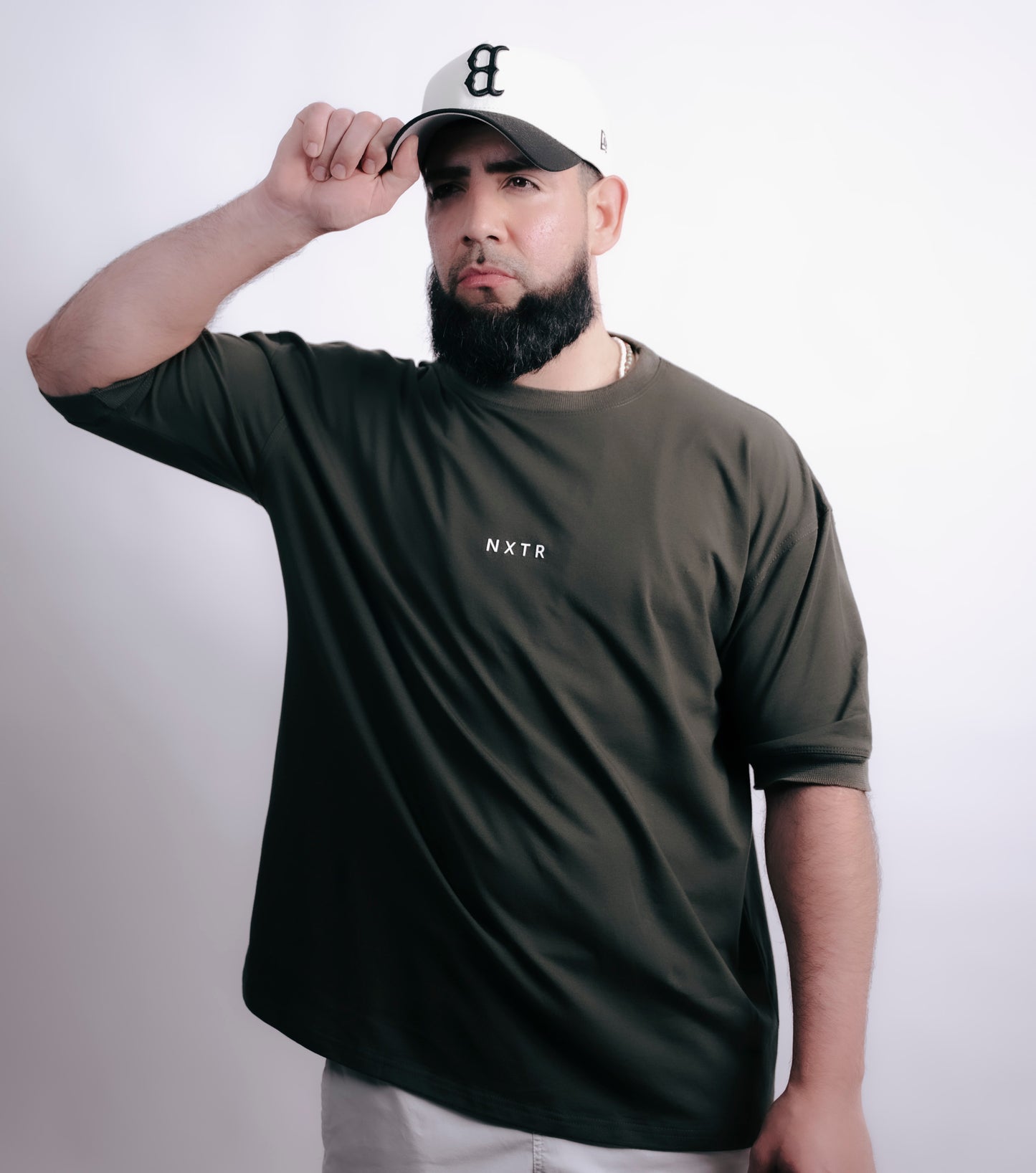 Military green oversized — subtle flex, strong presence.