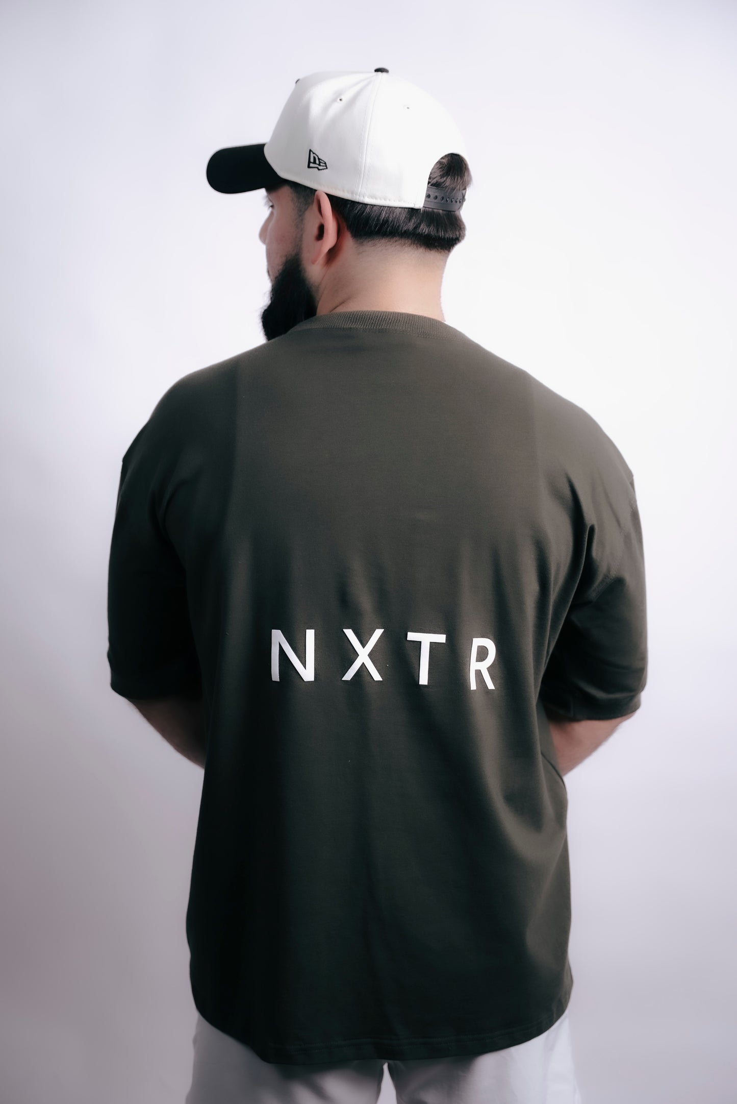 Military green oversized — subtle flex, strong presence.