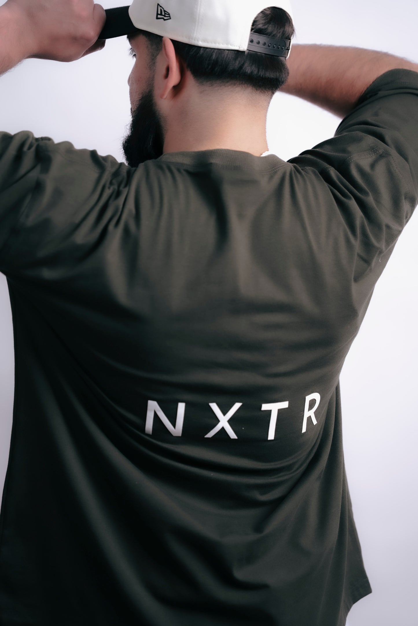 Military green oversized — subtle flex, strong presence.